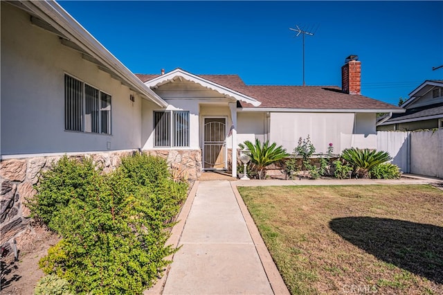 doorway to property featuring a yard