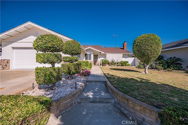 ranch-style house featuring a garage and a front lawn