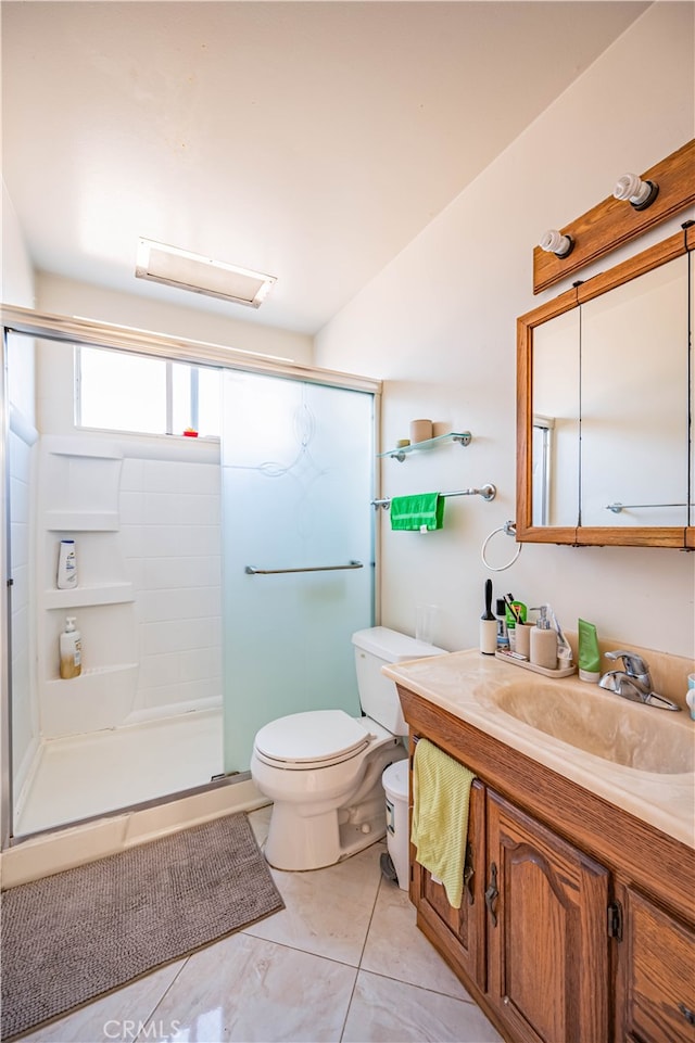 bathroom with tile patterned flooring, vanity, toilet, and an enclosed shower