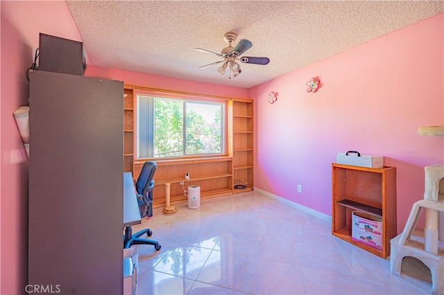 office space with ceiling fan and a textured ceiling