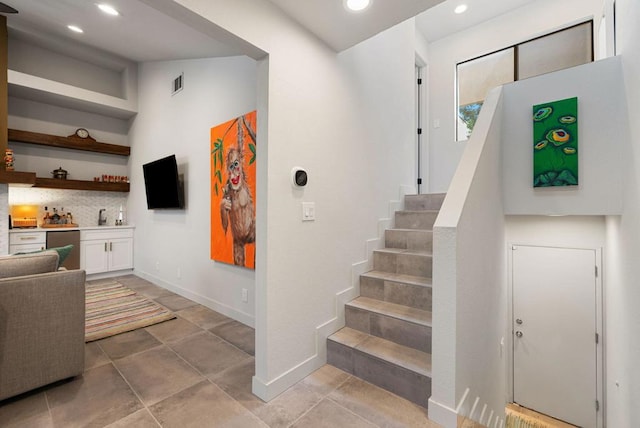 stairway featuring tile patterned floors