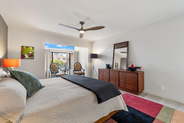 tiled bedroom featuring ceiling fan and access to outside