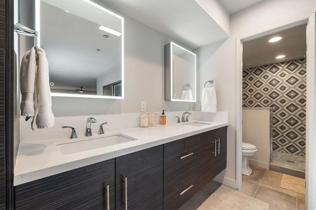 bathroom featuring tile patterned floors, vanity, and toilet