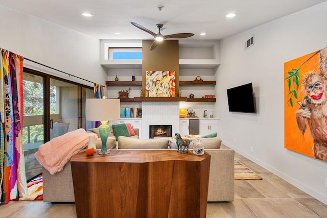 living room with ceiling fan and light tile patterned floors