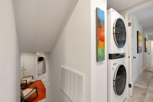 laundry room featuring stacked washer and clothes dryer