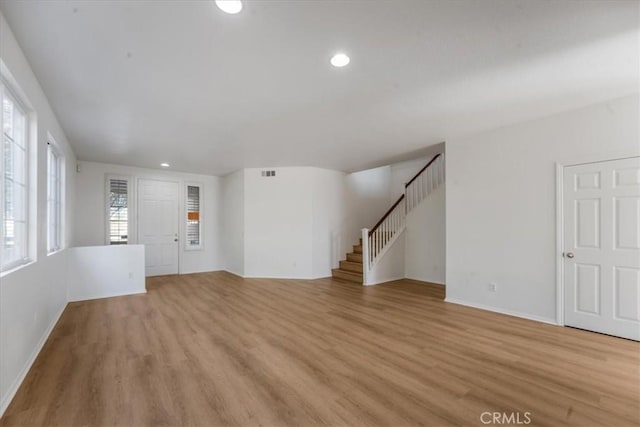 unfurnished living room with light hardwood / wood-style floors