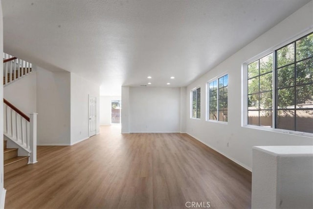 unfurnished living room featuring hardwood / wood-style flooring