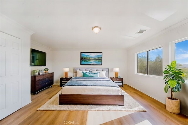 bedroom featuring light hardwood / wood-style floors and ornamental molding