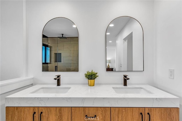 bathroom with walk in shower and vanity