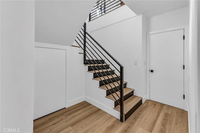 stairway featuring wood-type flooring