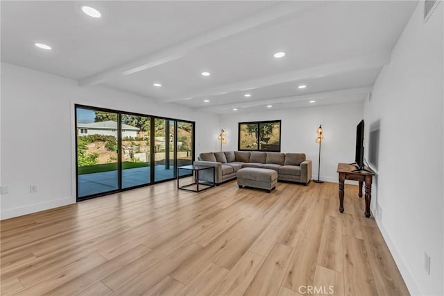 living room with beamed ceiling and light wood-type flooring