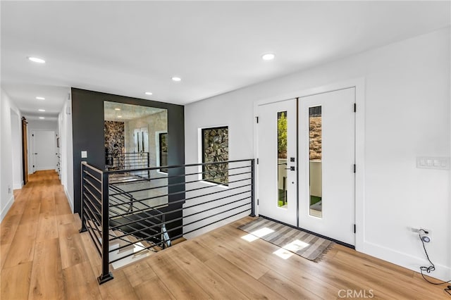 interior space with light hardwood / wood-style flooring and french doors