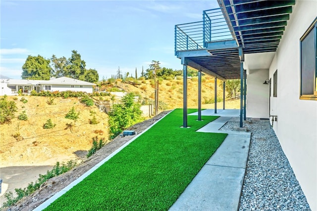 view of yard with a balcony