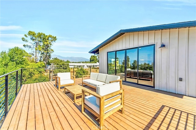 wooden terrace featuring a mountain view and an outdoor living space