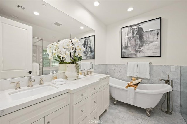 bathroom with vanity, tile walls, and shower with separate bathtub