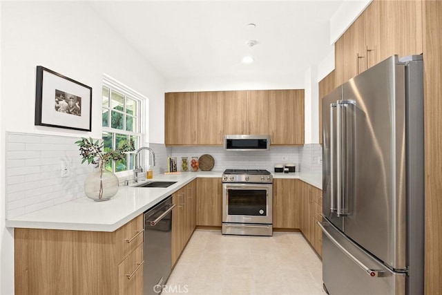 kitchen featuring backsplash, sink, and appliances with stainless steel finishes