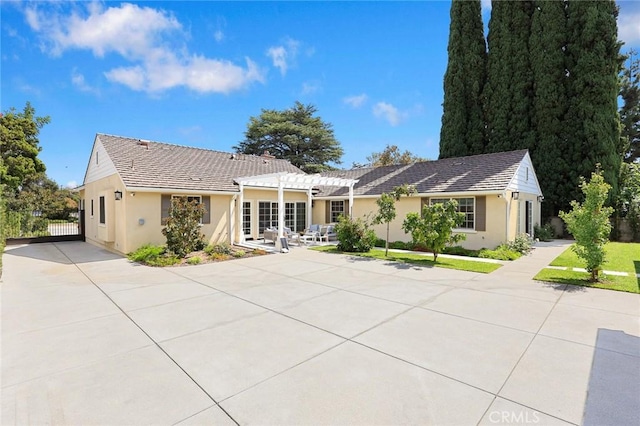 back of property featuring a pergola