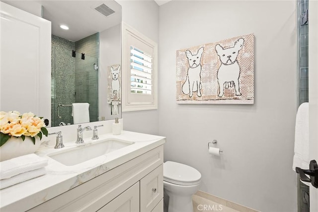 bathroom featuring vanity, toilet, and an enclosed shower