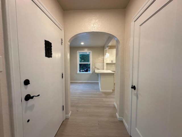 corridor featuring light hardwood / wood-style floors