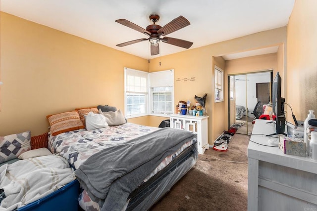 bedroom featuring ceiling fan, a closet, and carpet floors