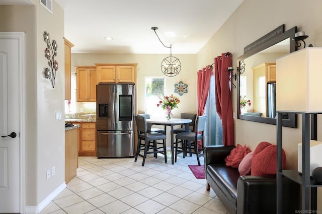 kitchen featuring light brown cabinets, hanging light fixtures, light tile patterned flooring, stainless steel fridge with ice dispenser, and stainless steel refrigerator