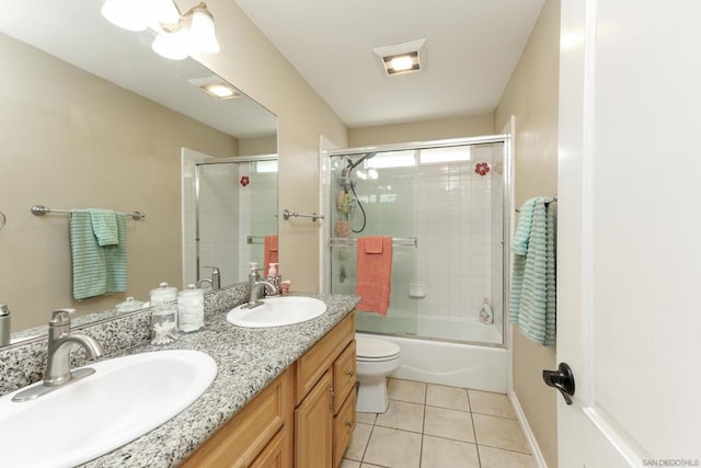 full bathroom with tile patterned floors, vanity, enclosed tub / shower combo, and toilet