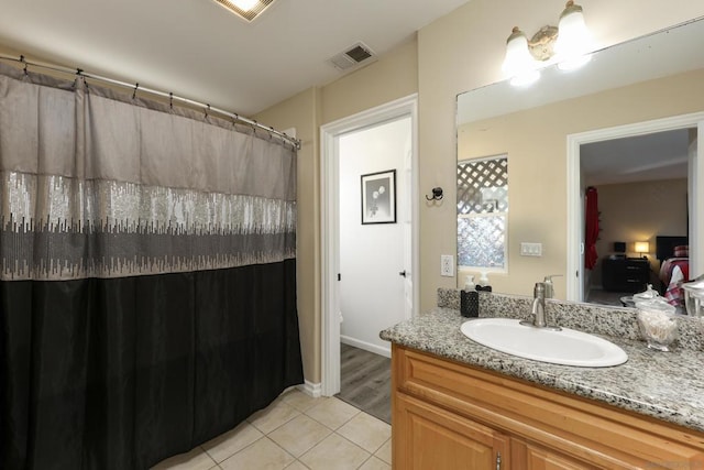 bathroom featuring tile patterned flooring and vanity