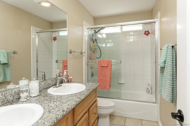 full bathroom with toilet, vanity, tile patterned floors, and enclosed tub / shower combo