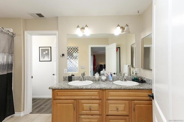 bathroom with hardwood / wood-style floors and vanity