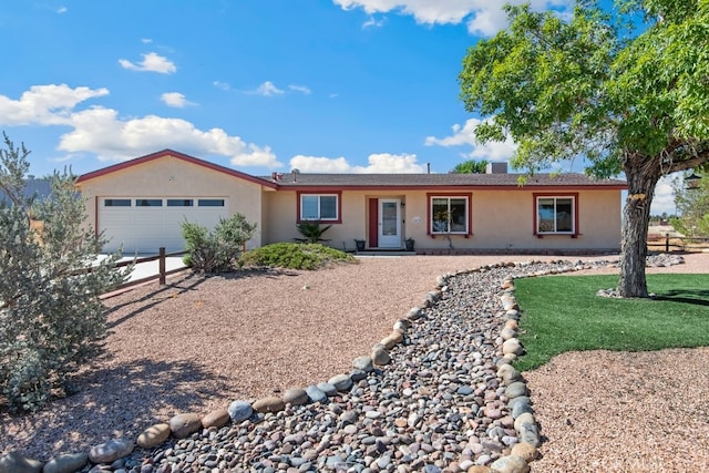 ranch-style house featuring a garage and a front lawn