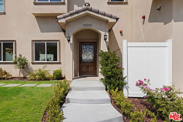 doorway to property with a yard