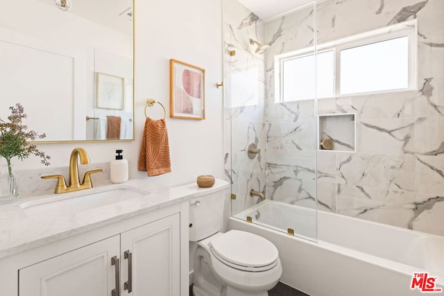 full bathroom featuring vanity, toilet, and tiled shower / bath