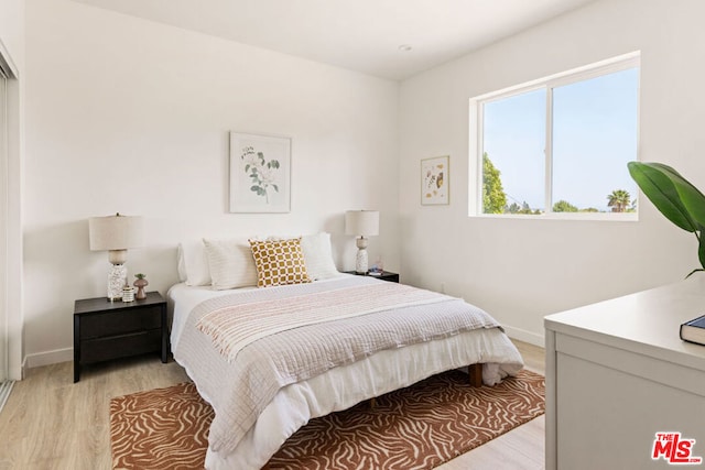 bedroom with light hardwood / wood-style floors