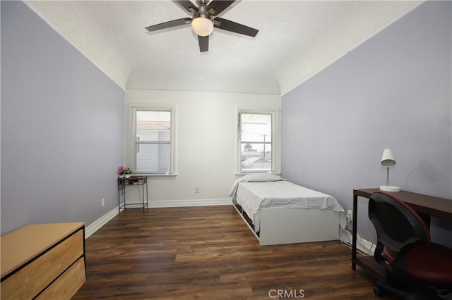 bedroom featuring ceiling fan, vaulted ceiling, dark hardwood / wood-style floors, and a textured ceiling