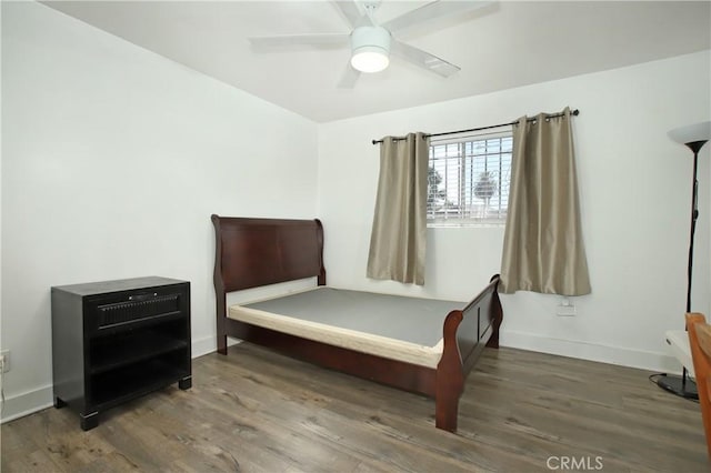 bedroom featuring ceiling fan and dark hardwood / wood-style floors