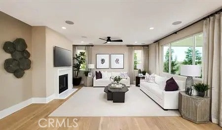 living room with light wood-type flooring and ceiling fan