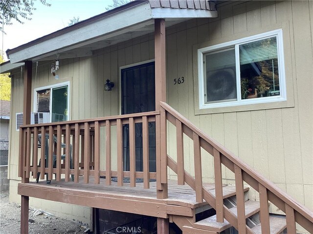 view of exterior entry featuring a wooden deck