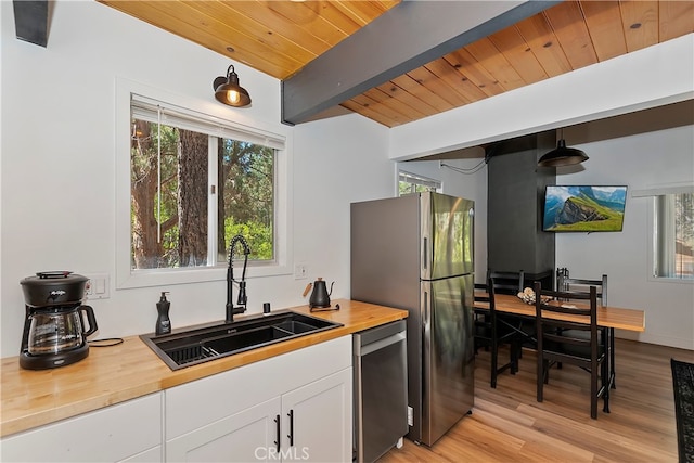 kitchen with sink, pendant lighting, stainless steel appliances, and a wealth of natural light