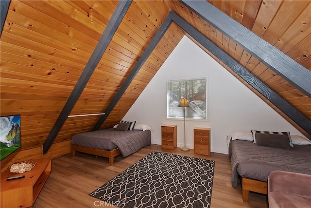 bedroom with vaulted ceiling with beams, light hardwood / wood-style flooring, and wood ceiling