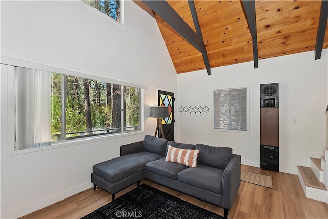 living room with wooden ceiling, beam ceiling, light hardwood / wood-style flooring, and high vaulted ceiling