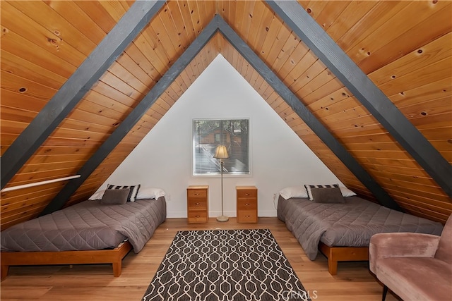 bedroom featuring light wood-type flooring, vaulted ceiling with beams, and wood ceiling