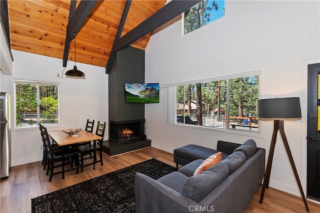 living room with beamed ceiling, a fireplace, hardwood / wood-style floors, and wood ceiling