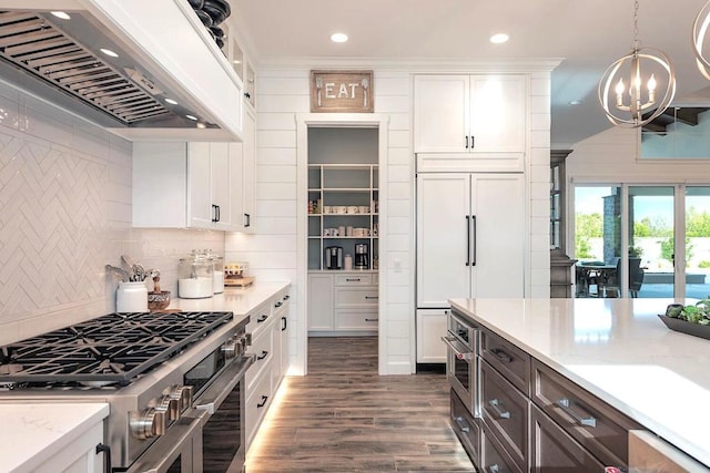 kitchen with custom range hood, hanging light fixtures, dark wood-type flooring, white cabinets, and high quality appliances