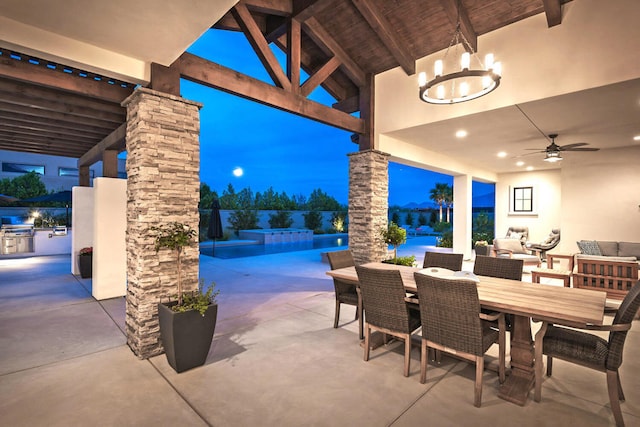 patio terrace at dusk featuring ceiling fan, an outdoor living space, and a jacuzzi