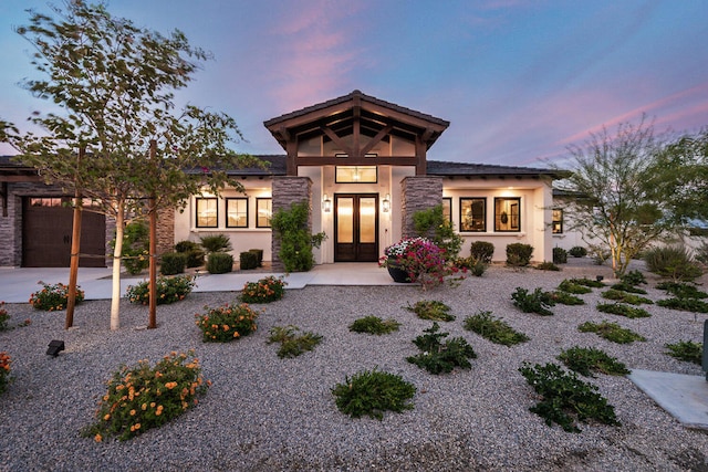 view of front of house with a garage and french doors