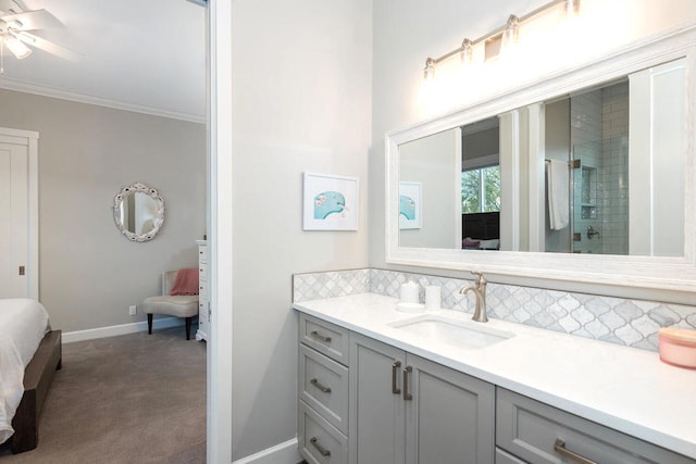 bathroom featuring tasteful backsplash, vanity, crown molding, ceiling fan, and a shower with door