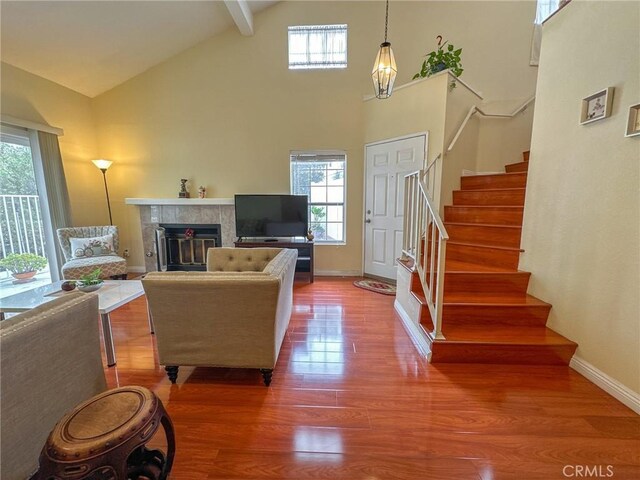 13168 Pinnacle Ct, Chino Hills, CA 91709 - living room with healthy amount of natural light, high vaulted ceiling, a tile fireplace, and stairway