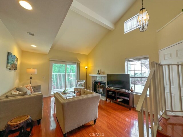 13168 Pinnacle Ct, Chino Hills, CA 91709 - living area with light wood finished floors, healthy amount of natural light, a tiled fireplace, high vaulted ceiling, and recessed lighting