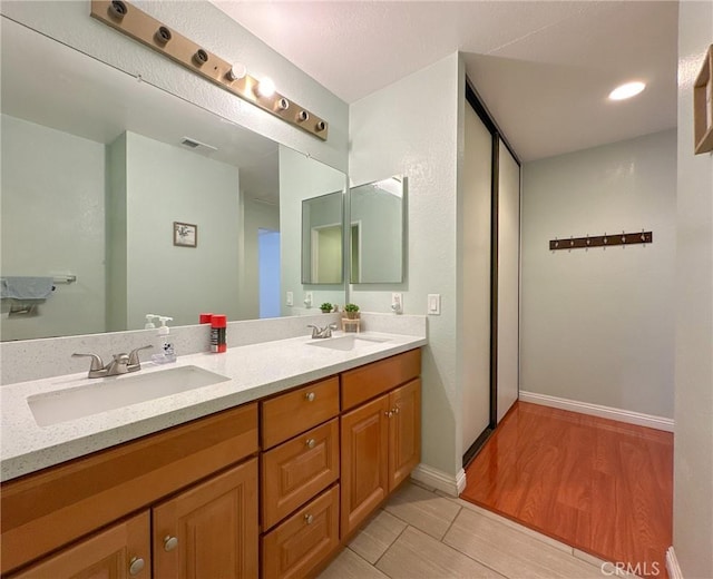 bathroom with wood-type flooring and vanity