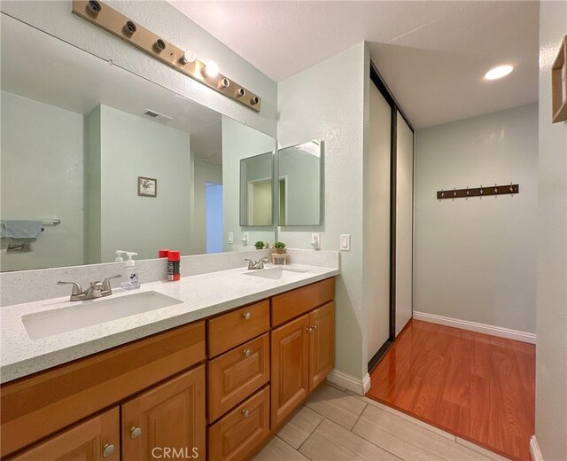 13168 Pinnacle Ct, Chino Hills, CA 91709 - bathroom featuring double vanity and wood finished floors